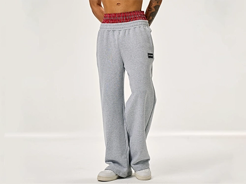 Production 23 Model showcasing gray sweatpants with a built-in checkered panel faux-layer design.