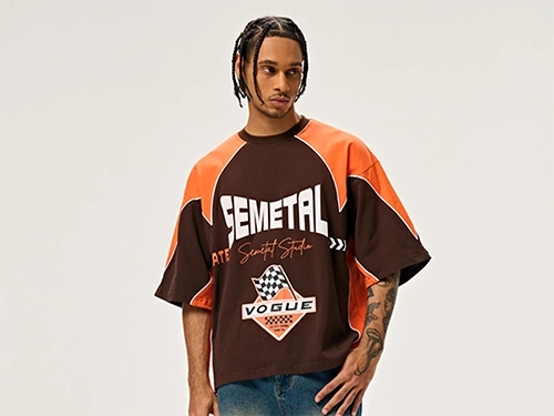 Model wearing a custom logo orange and brown color-blocked t-shirt.