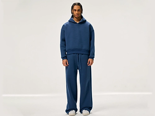 Production 19 Model wearing a stylish navy blue tracksuit set (hoodie and joggers).
