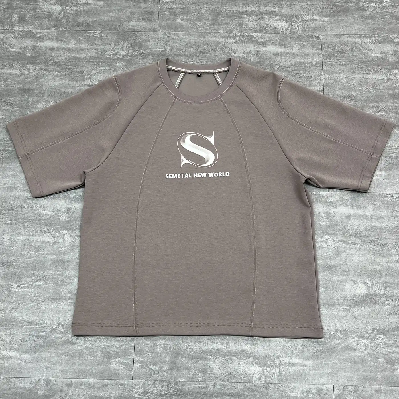 Flat lay front view of the best custom cut and sew streetwear t-shirt in taupe color