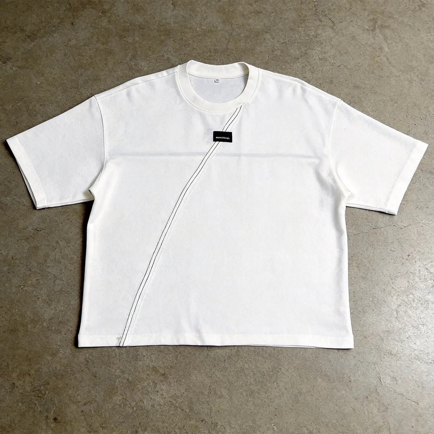 Flat lay front view of the best-selling 250GSM custom woven label oversized t-shirt showing diagonal seam