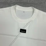 Close-up collar detail of the cut and sew t-shirt OEM sample featuring chest woven label patch