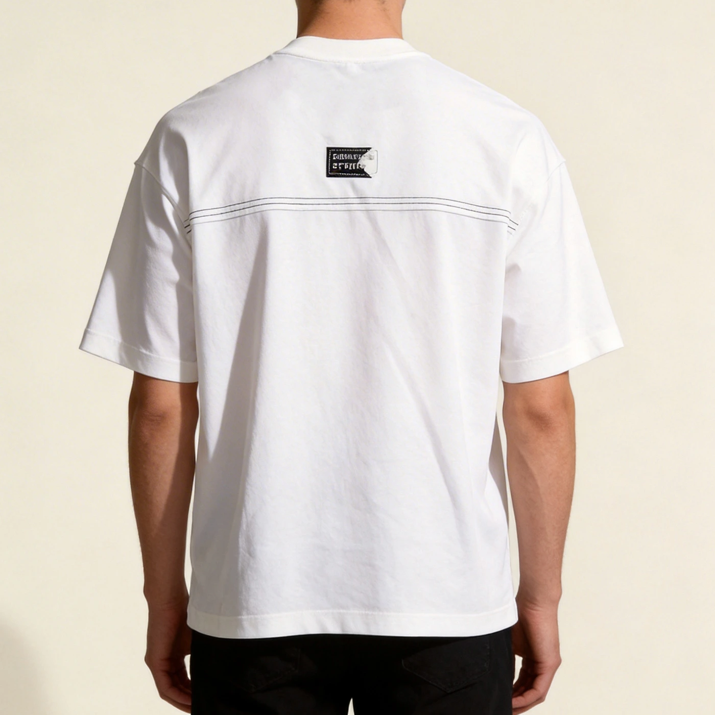 Back straight view of model wearing the custom woven label oversized t-shirt manufactured by Qianshiwear