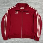 Front view of red custom track jacket with white side stripes and vintage embroidery.
