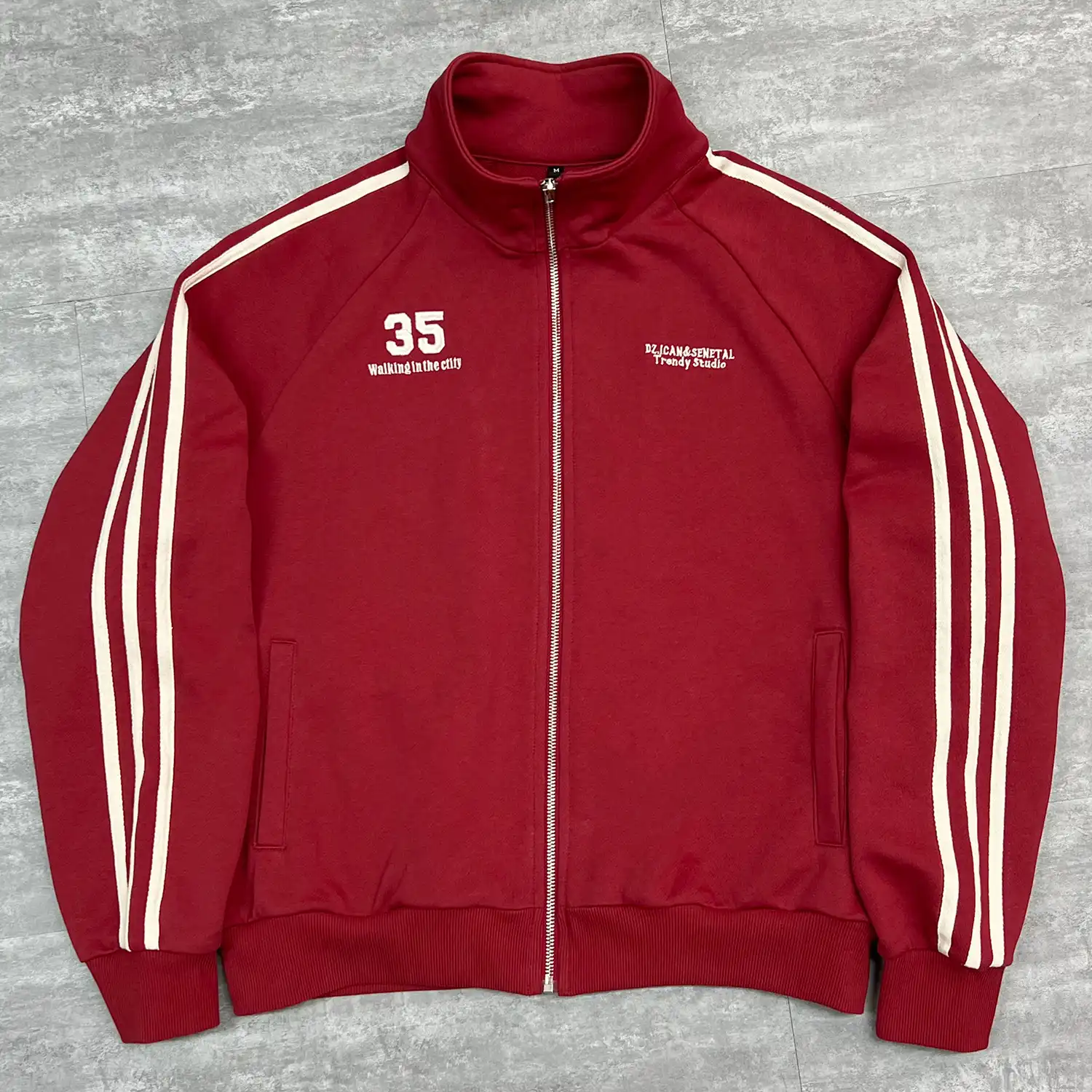 Back view of custom embroidered track jacket highlighting Semetal neck logo.