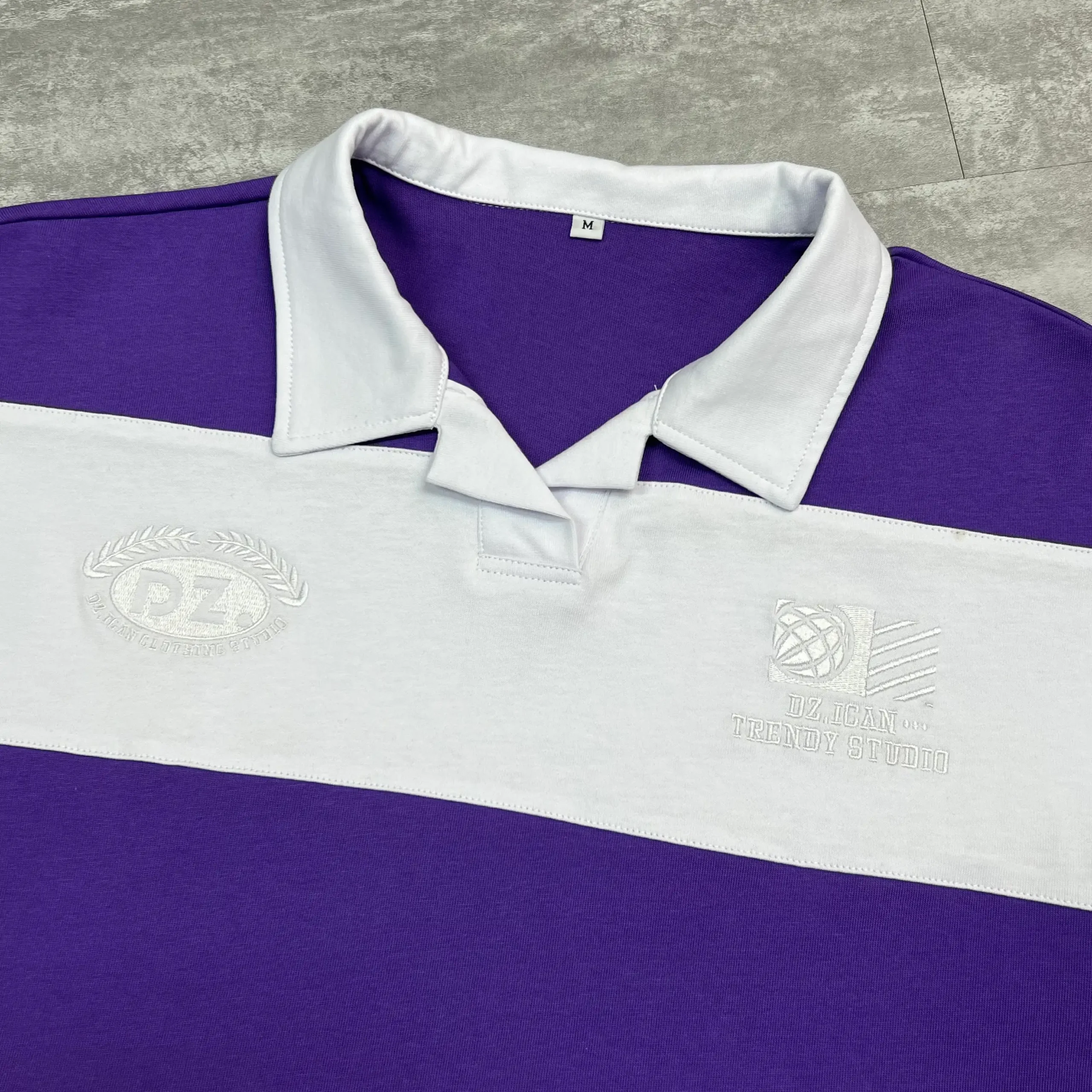 Custom Striped Polo Shirt 250GSM Combed Cotton 50 MOQ OEM 5 Close-up of contrast polo collar and high-density chest embroidery on streetwear top.