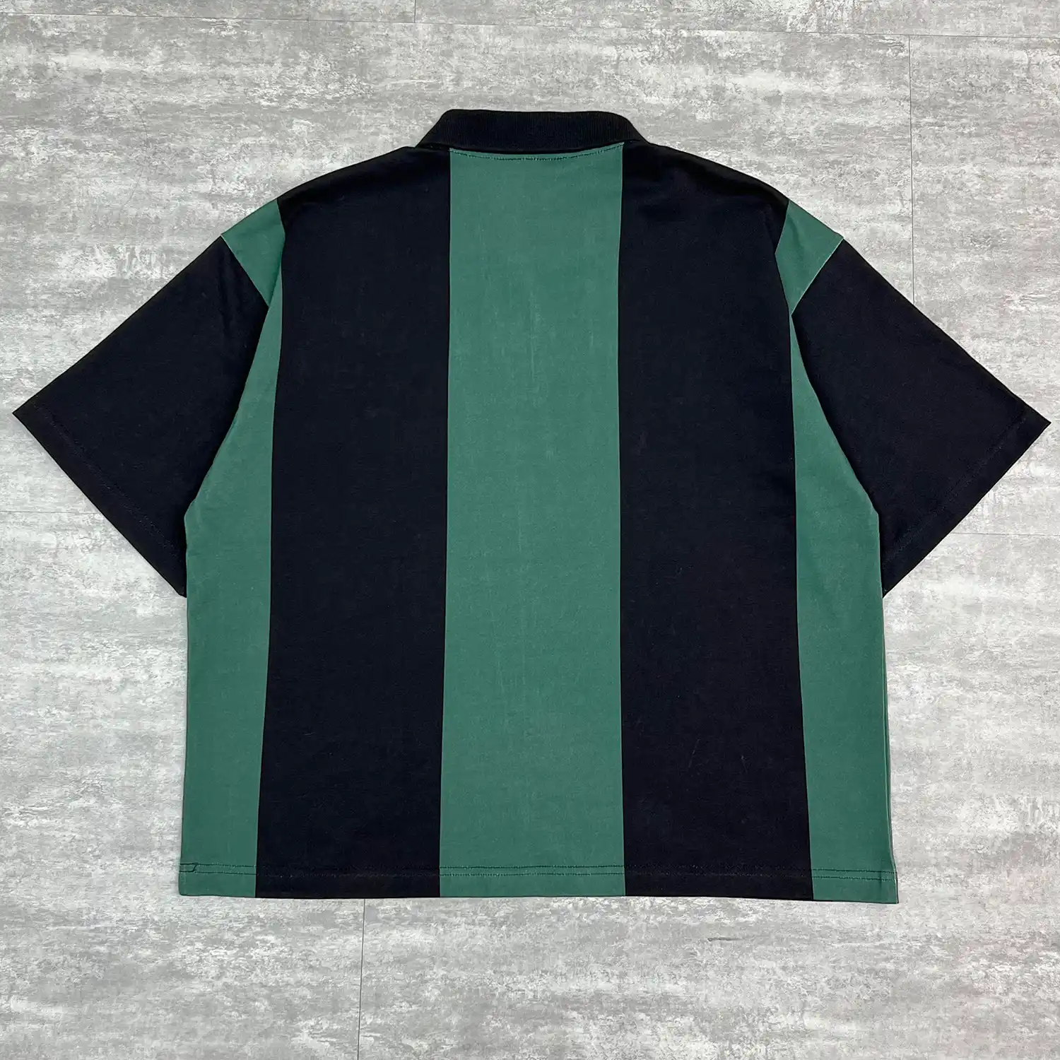 Back flat lay of custom striped polo shirt showing clean vertical block stripes.