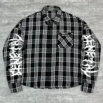 Close up of frayed raw edge hem on custom oversized mesh shirt.