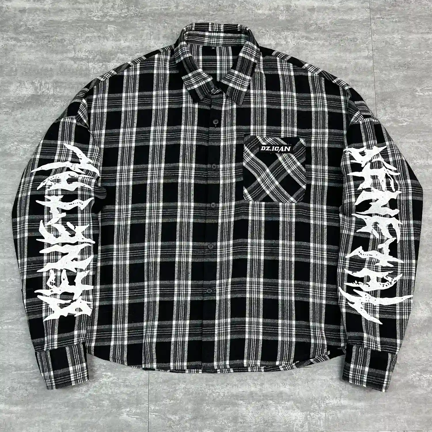 Close up of frayed raw edge hem on custom oversized mesh shirt.
