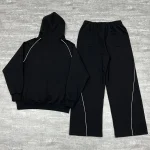 Back flat lay of the OEM streetwear tracksuit set highlighting the continuous curved piping down the pant legs.