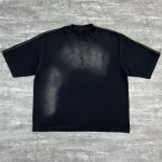 Flat lay front view of black custom washed oversized t-shirt with rhinestone logo.