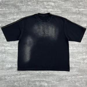 Flat lay front view of black custom washed oversized t-shirt with rhinestone logo.