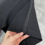 Back flat lay of the OEM streetwear tracksuit set highlighting the continuous curved piping down the pant legs.