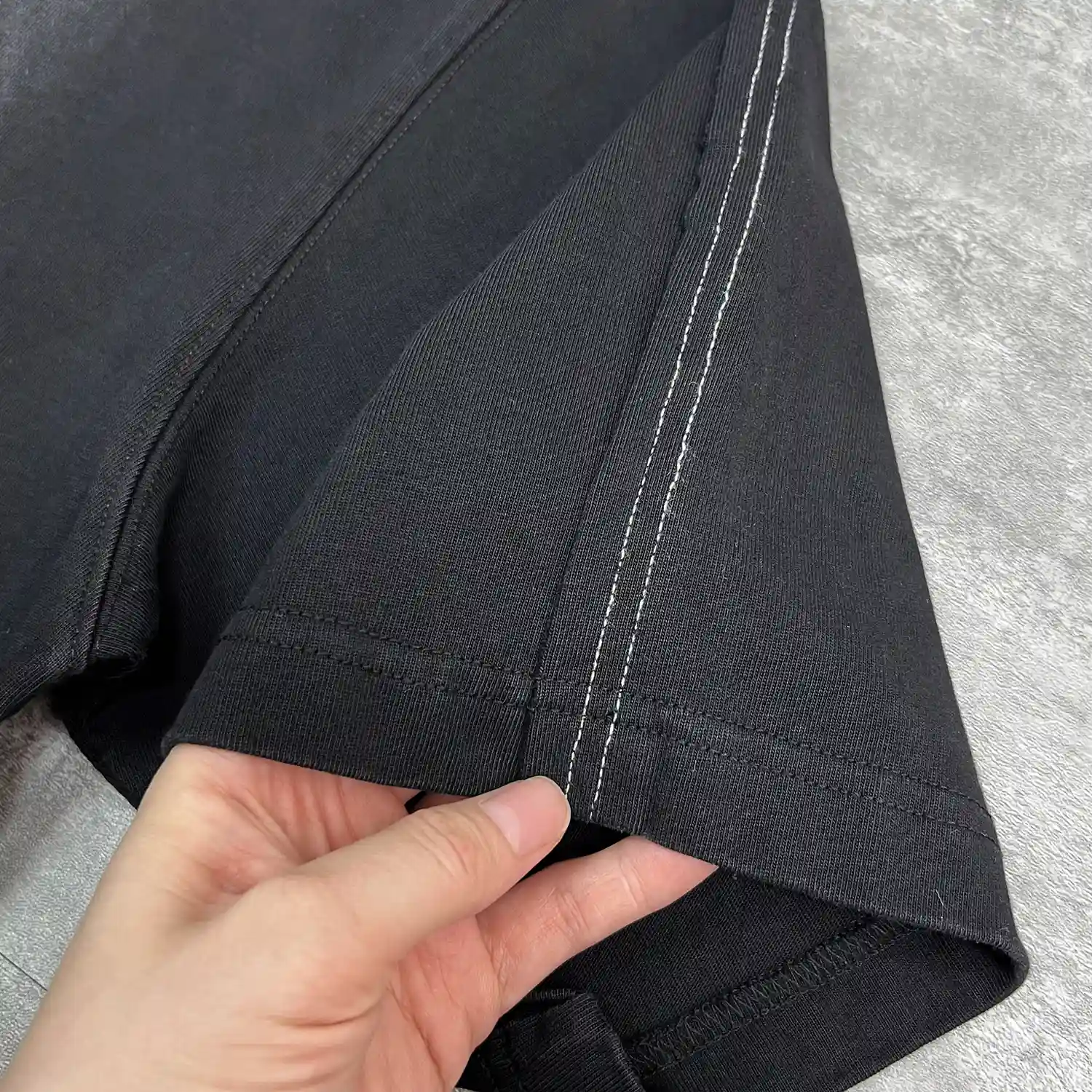 Back flat lay of the OEM streetwear tracksuit set highlighting the continuous curved piping down the pant legs.