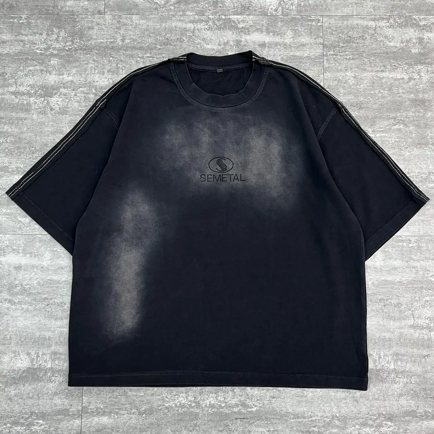 Angled front flat lay highlighting the boxy fit of the custom washed oversized t-shirt.