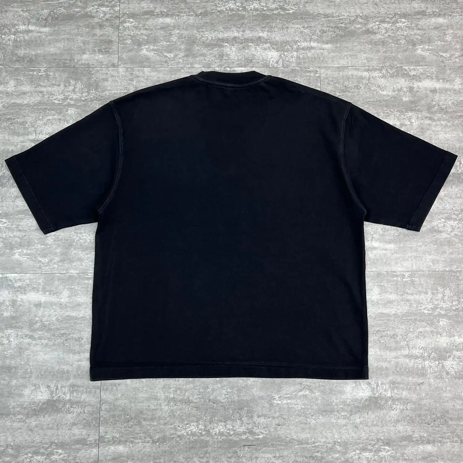 Back flat lay of black vintage drop-shoulder streetwear t-shirt ready for wholesale.