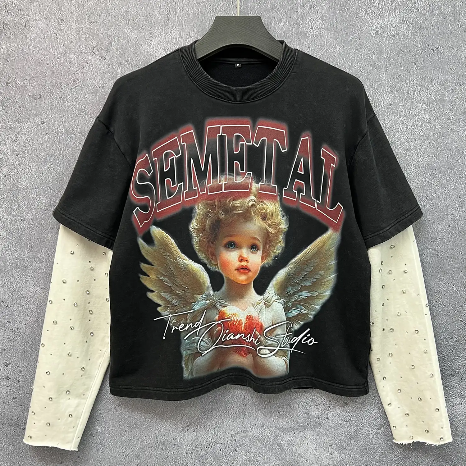 Hanging retail display front view of custom oversized angel shirt for B2B buyers.