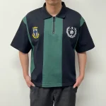 Model wearing the relaxed fit custom striped polo shirt in black and green.