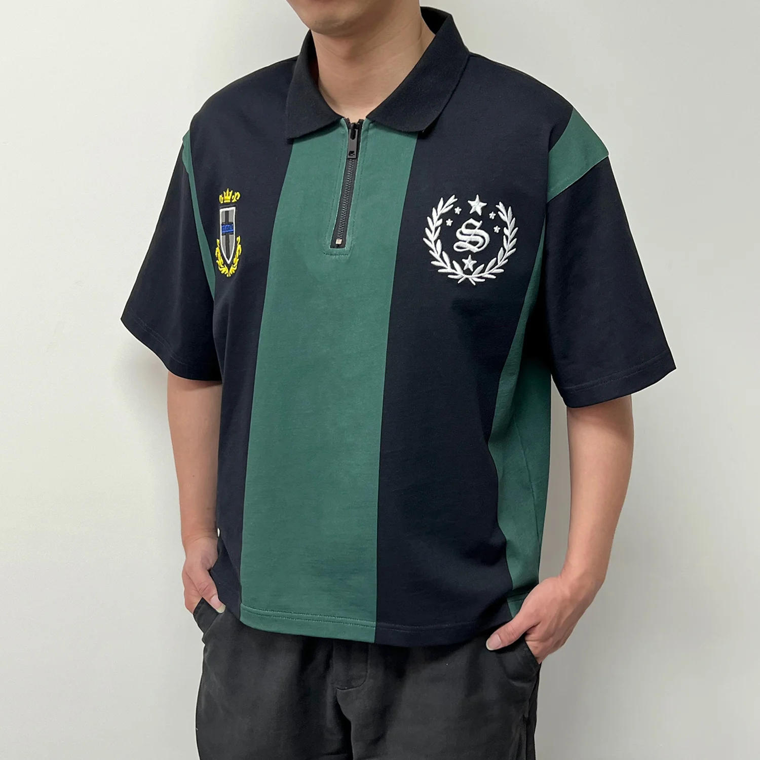 Angled modeling shot of retro vertical striped OEM streetwear polo shirt.