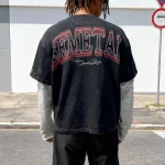 Back presentation of the oversized contrast stitch mesh shirt on model.
