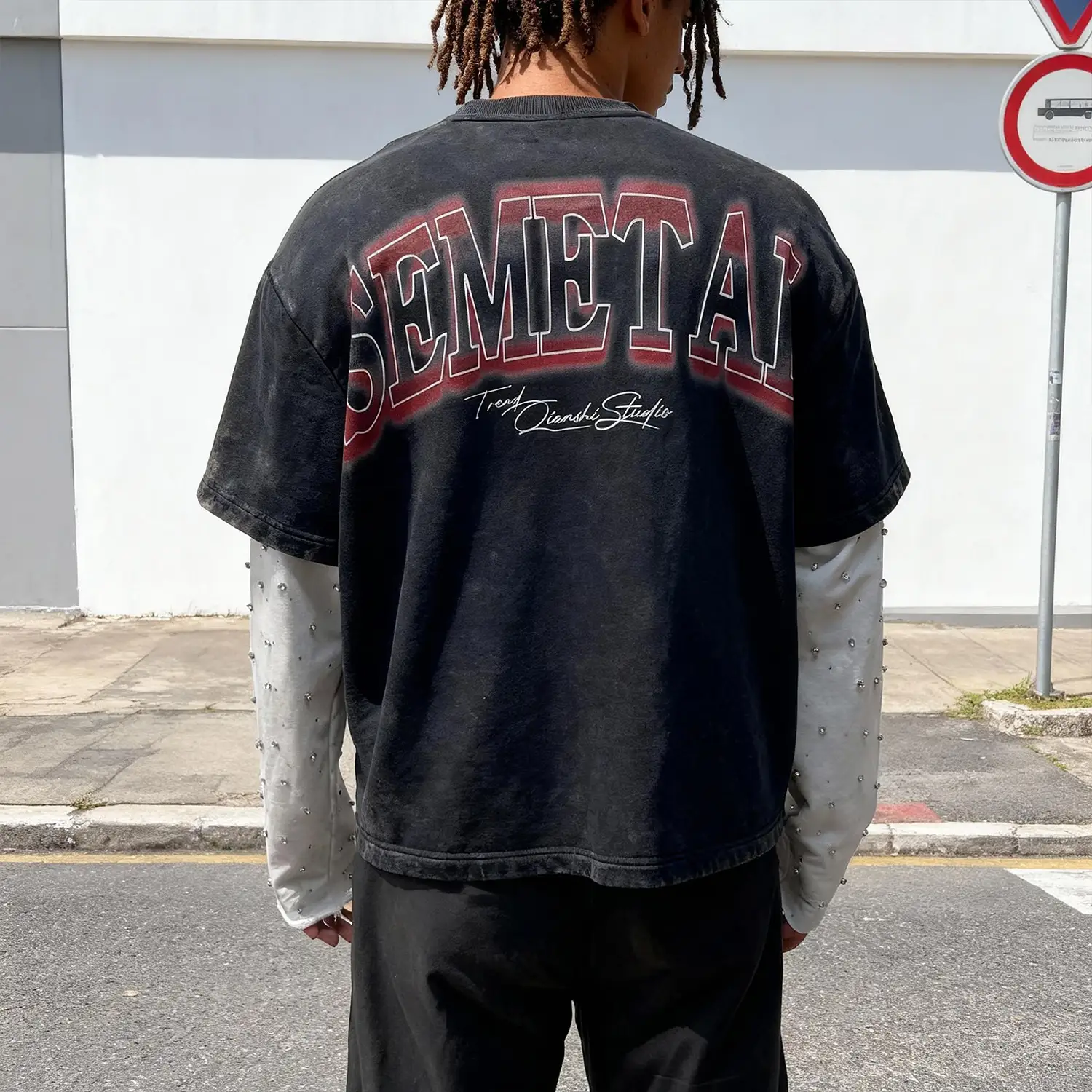 Back presentation of the oversized contrast stitch mesh shirt on model.