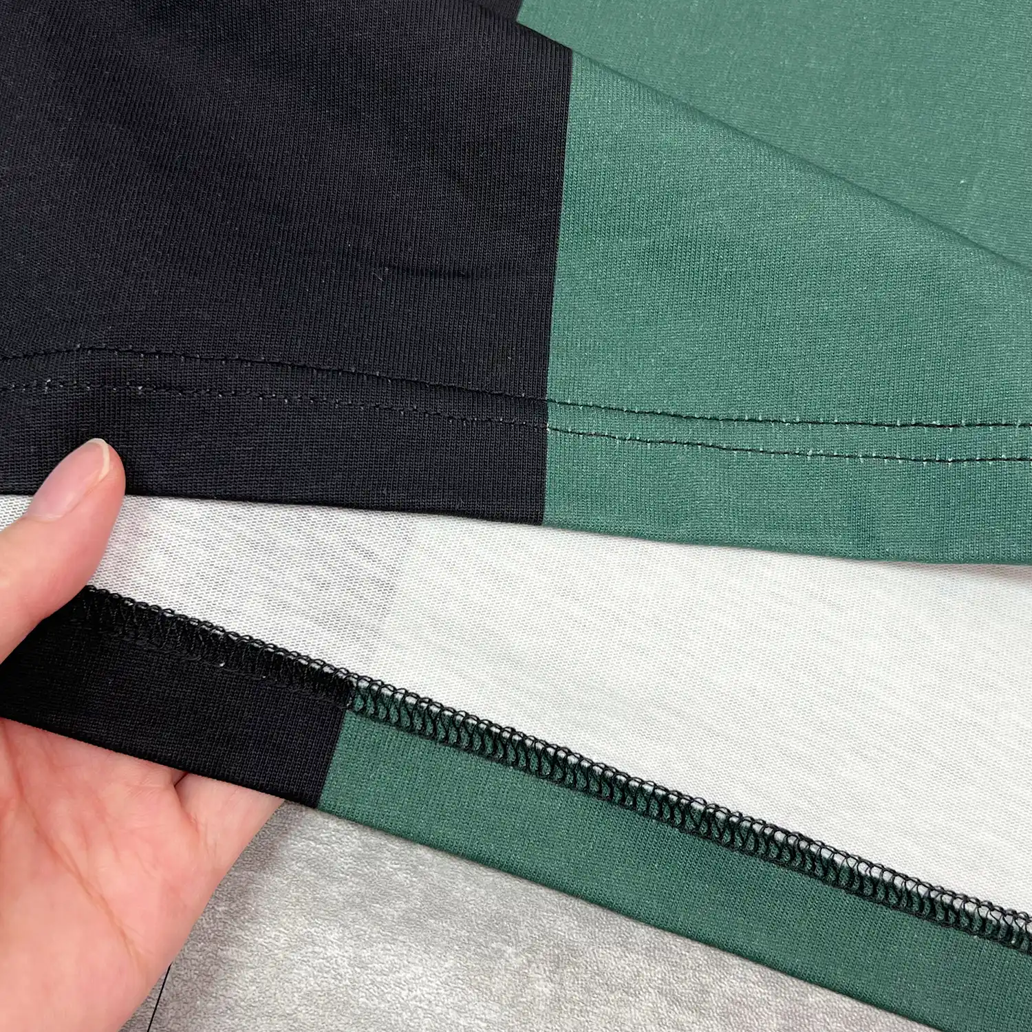 Interior fabric detail showing the printed color face and white cotton base with twin-needle hem.