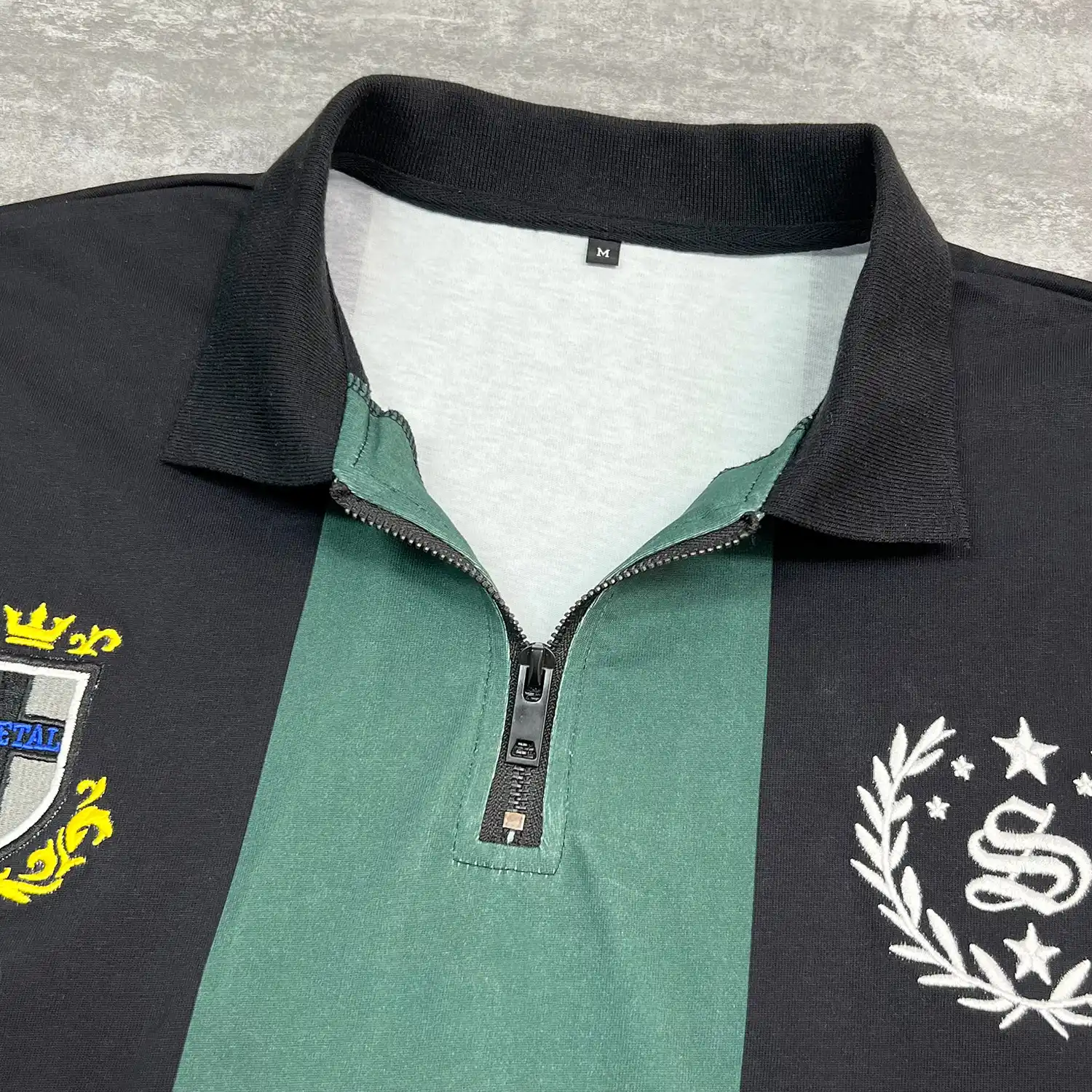 Close-up of the premium quarter-zip hardware and ribbed collar on the streetwear polo.