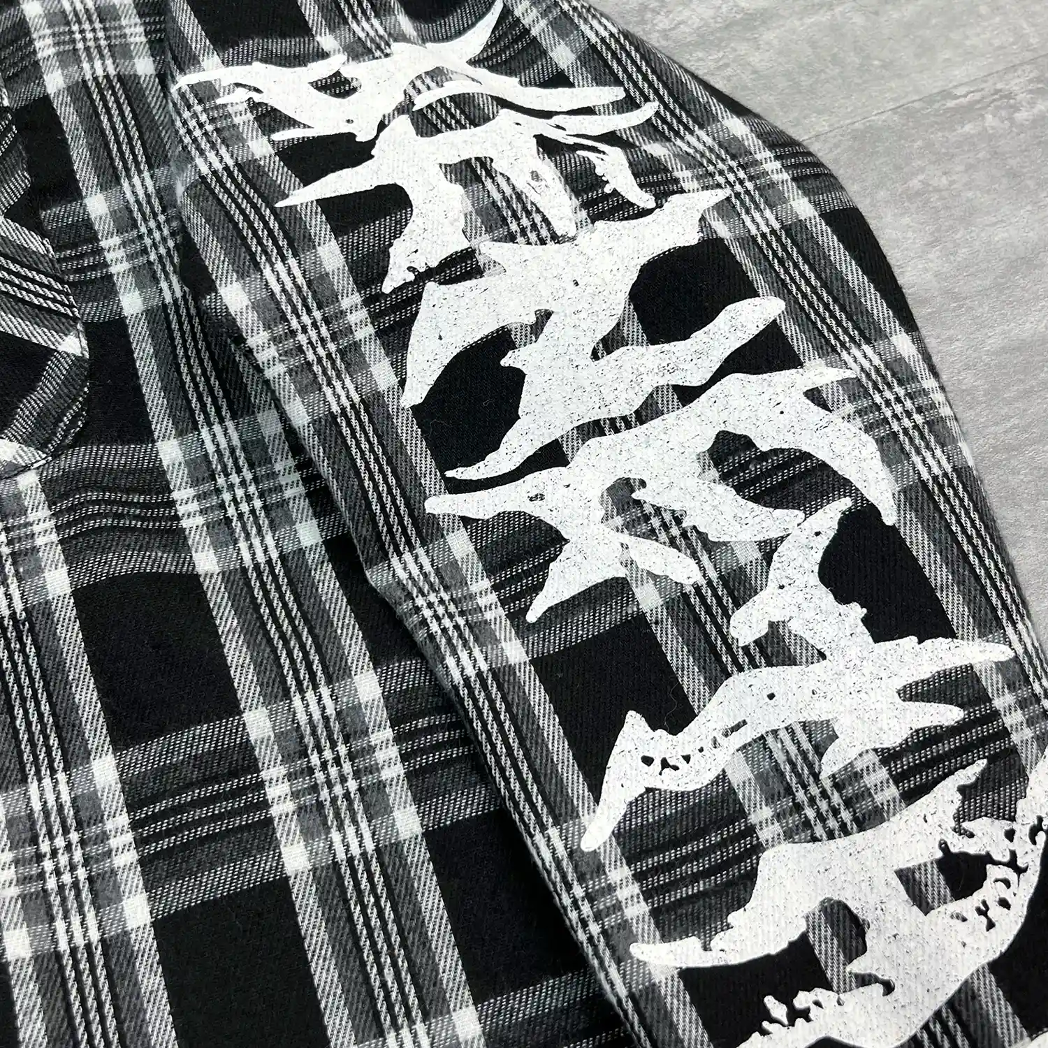 Flat lay front view of black contrast stitch mesh shirt for B2B buyers.