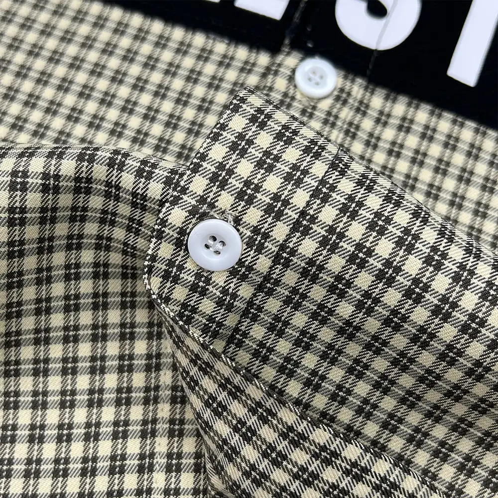 custom plaid shirt cuff button and plaid fabric close up